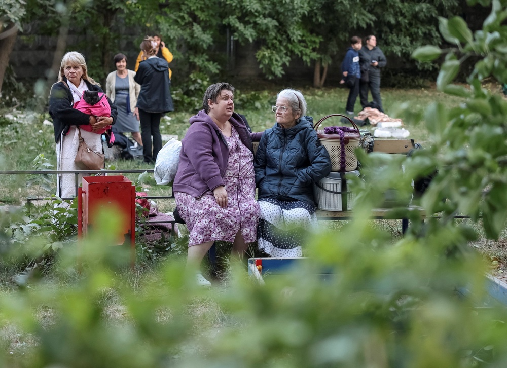 Residents gather at a site of an apartment building destroyed by a Russian missile strike in Kyiv (Reuters)