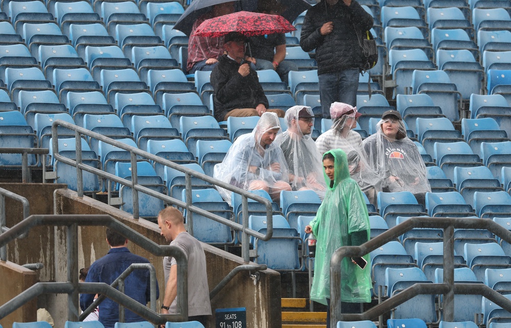 Spectators look on as rain stops play during day one of the 1st Rothesay Test Match between England and Pakistan at Headingley (Getty)