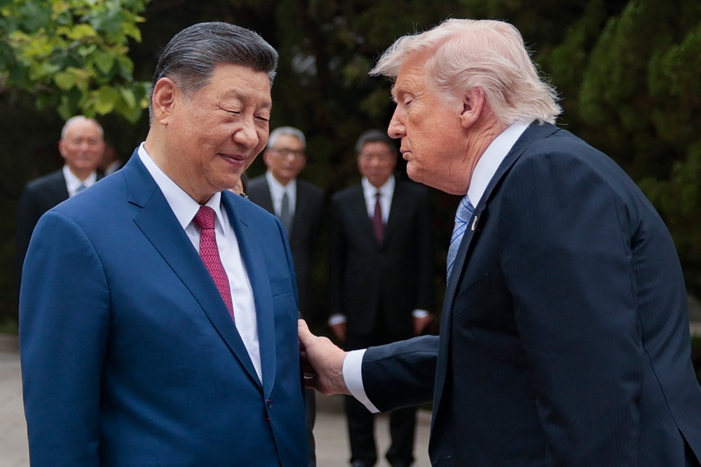 President Donald Trump (R) gestures to China's President Xi Jinping as he leaves after a visit to Zhongnanhai Garden in Beijing on May 15 (AFP/Getty)