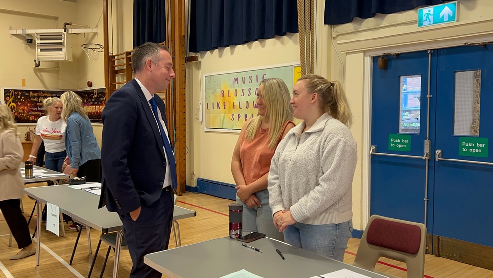Education minister Paul Givan speaks to teachers at Dromore High School on GCSE results day. (Claudia Savage /PA).