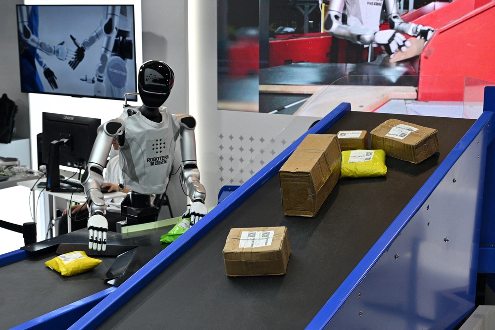 A humanoid robot by Robotera is seen working with packages during the World Artificial Intelligence Conference (WAIC) in Shanghai on July 18, 2026 (AFP/Getty)
