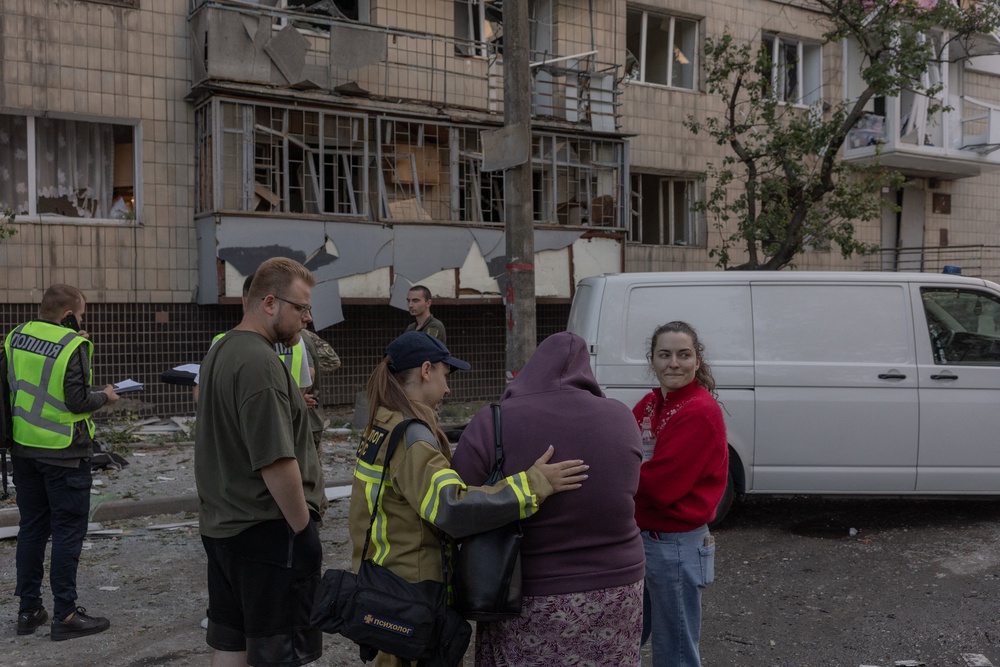 Emergency services console the relative of a victim hit by Russian strikes (AFP/Getty)