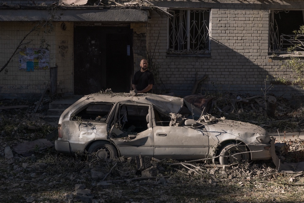 A Ukrainian man surveys the damage after Russian strikes hit residential areas overnight (AFP/Getty)