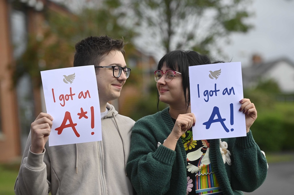 Wojciech Sobiecki celebrates his GCSE results with his sister Nikola Sobiecka at Hazelwood Integrated College in Newtownabbey, North Belfast (Mark Marlow/PA) (PA Wire)