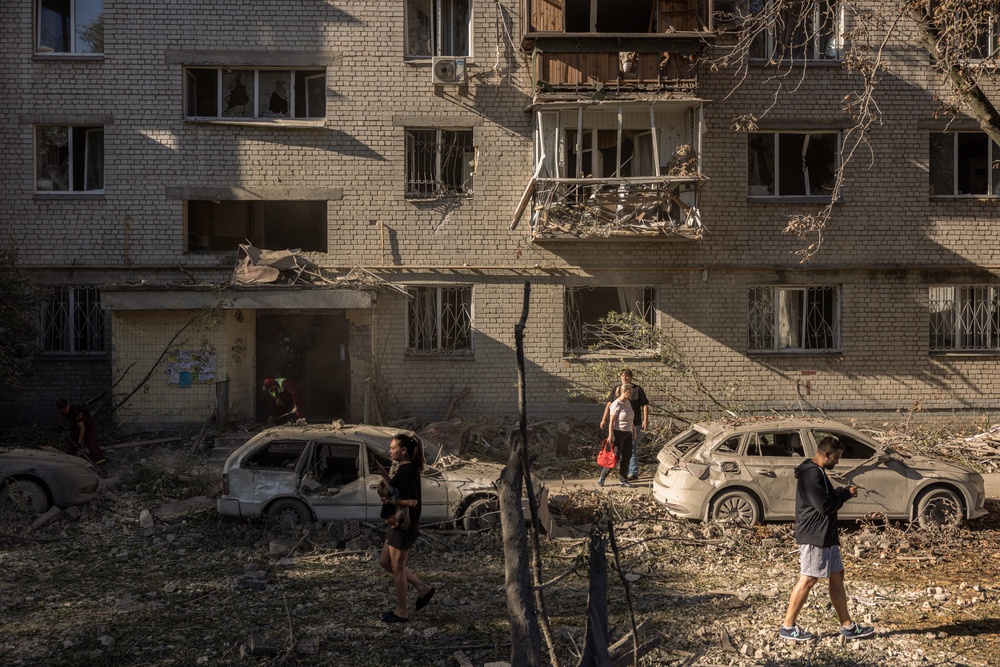Residents walk through debris in a courtyard following a Russian missile strike on August 20, 2026 in Kyiv, Ukraine. Apartment blocks and warehouses were hit across the city overnight following a large barrage of missiles, with a children's hospital and school also damaged (Getty)