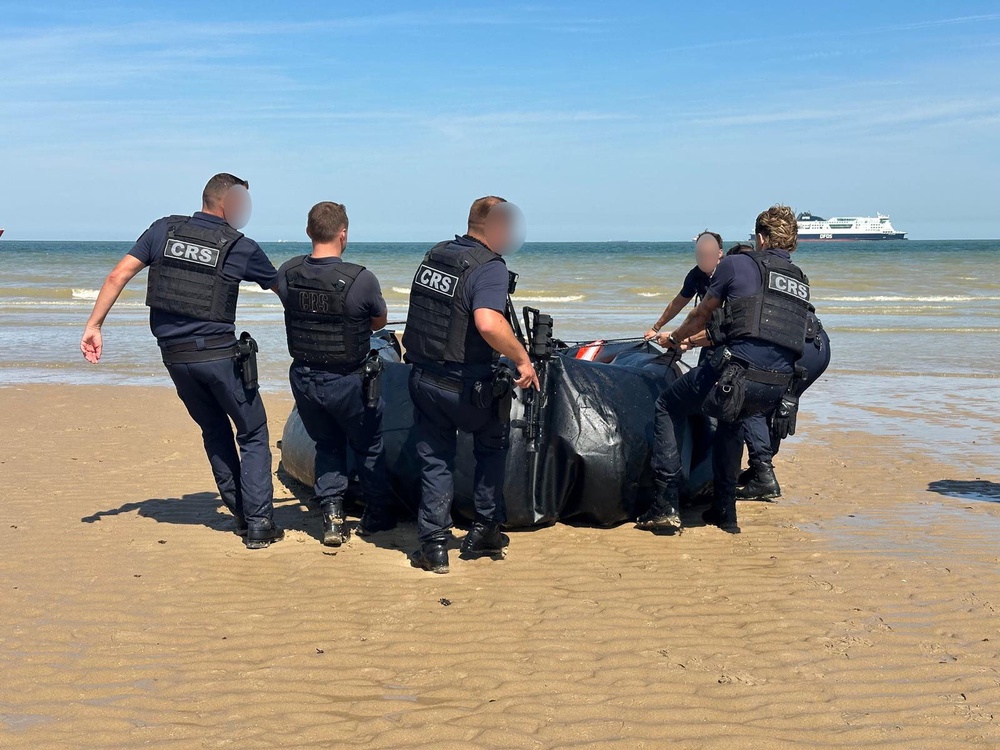 French police officers seizing a small boat (PA)