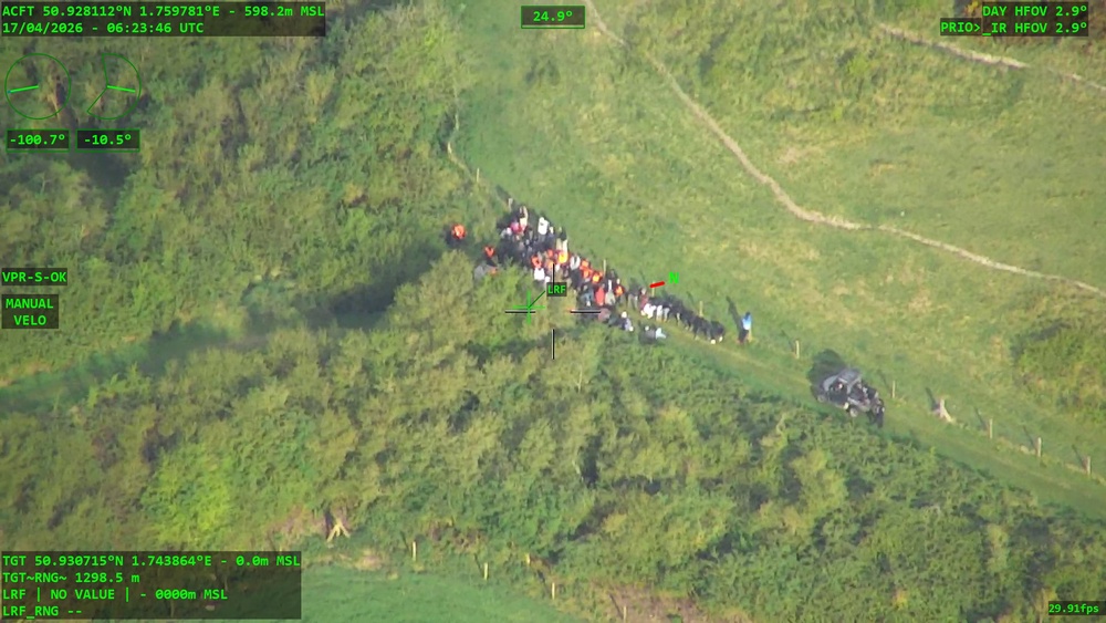 Police surveillance of a large group of migrants attempting a small boat launch (PA)