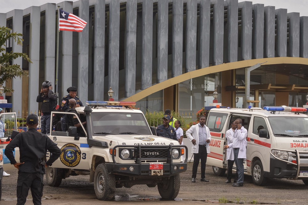 Liberia's national police officers stand guard for a plane carrying migrants deported from the US (AFP/Getty)