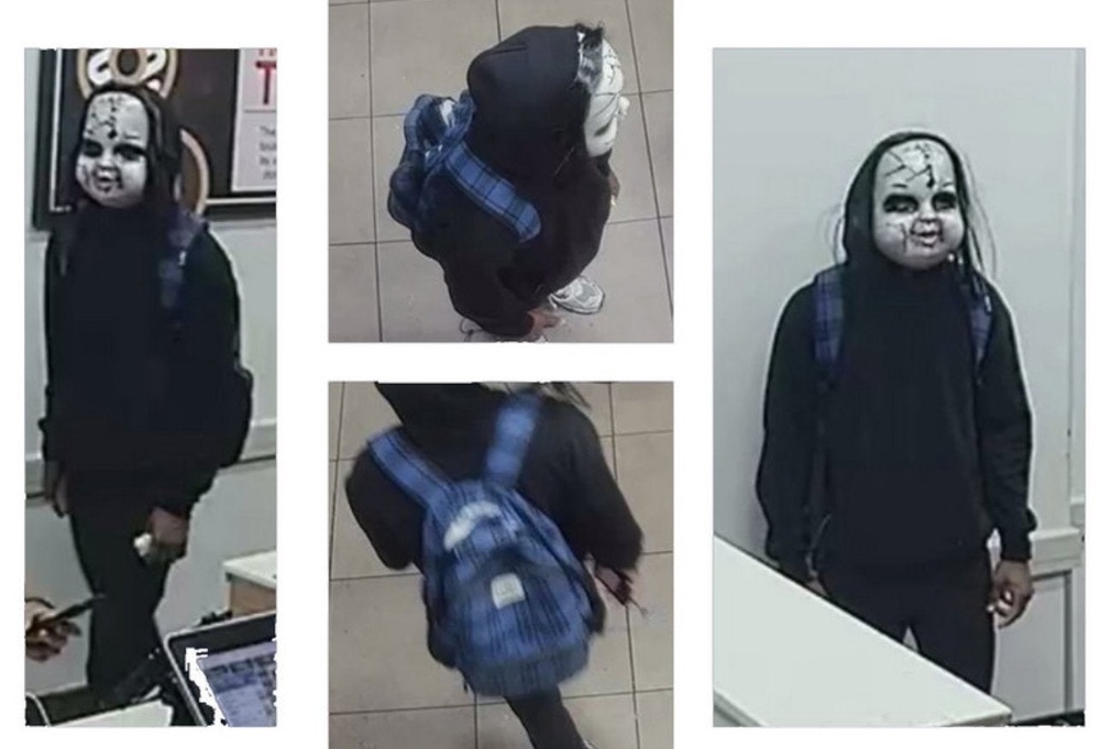 Hughes, believed to be pictured here wearing the Chucky mask, could face charges including terroristic threats, harassment, simple assault, reckless endangerment and intimidation (Philadelphia Police Department)