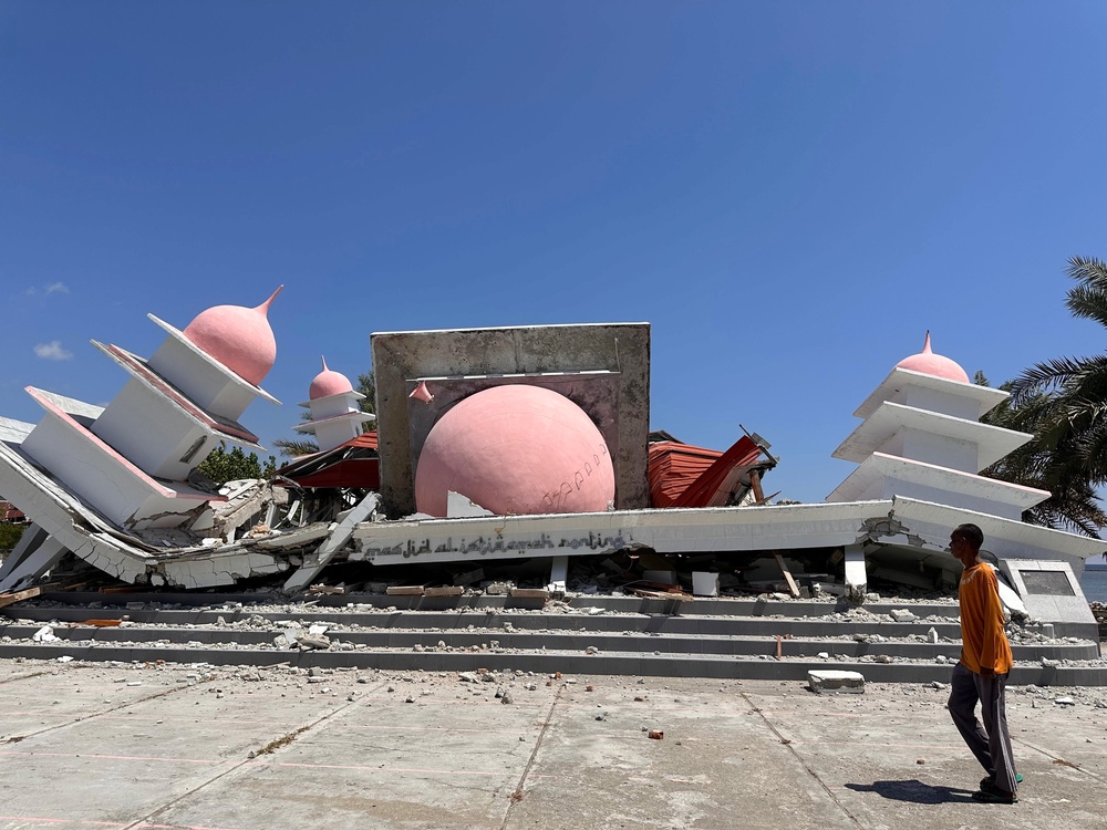 A man walks past a mosque collapsed during an earthquake in Lamba Leda, Indonesia, on Tuesday. Tens of thousands of people were displaced by the quake (Copyright 2026 The Associated Press. All rights reserved.)