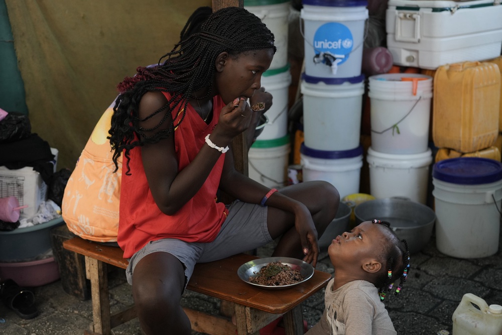 Children eat at a shelter for families displaced by gang violence in Port-au-Prince, Haiti, Wednesday, Aug. 19 (AP Photo/Odelyn Joseph)