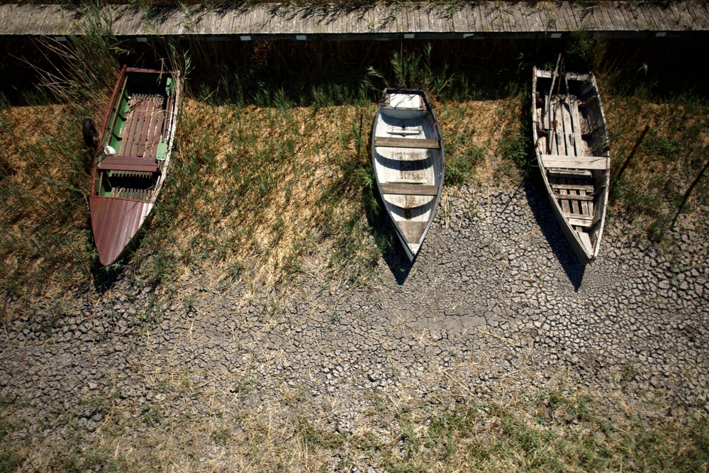 Boats lie on cracked soil at a dried-out marina on Lake Velence, Hungary, on Aug. 13. 2026. (AP Photo/Bela Szandelszky) (Copyright 2026 The Associated Press. All rights reserved.)