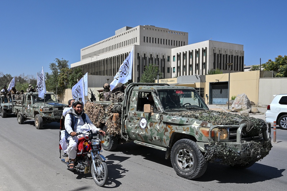 A convoy of Taliban security personnel take part in a parade in front of the former US Embassy building in Kabul (AFP/Getty)
