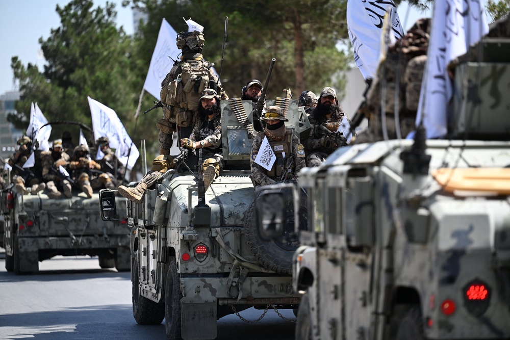 A convoy of Taliban security personnel take part in a parade in front of the former US Embassy building in Kabul (AFP/Getty)