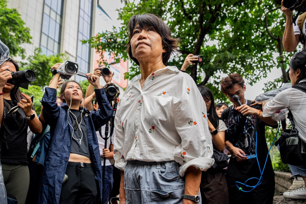 Elizabeth Tang Yin-ngor (C), wife of former union leader Lee Cheuk-yan, leaves the West Kowloon Magistrates' Courts after the verdict in the national security trial of two pro-democracy Tiananmen activists (AFP/Getty)