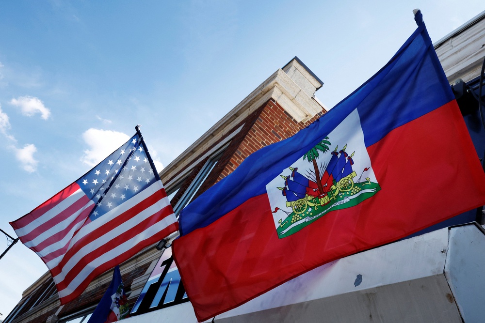 The U.S. and Haitian flags flutter in Boston, Massachusetts (REUTERS/Brian Snyder)