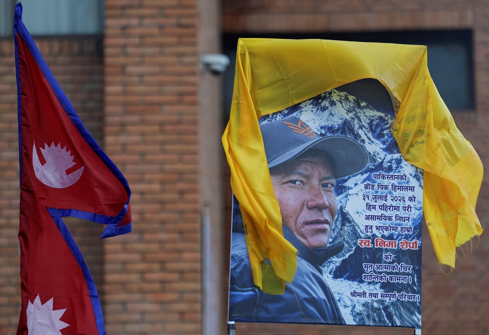 A portrait of Nima Sherpa is kept on the vehicle designated to transport his body at Tribhuvan International Airport in Kathmandu (Reuters)