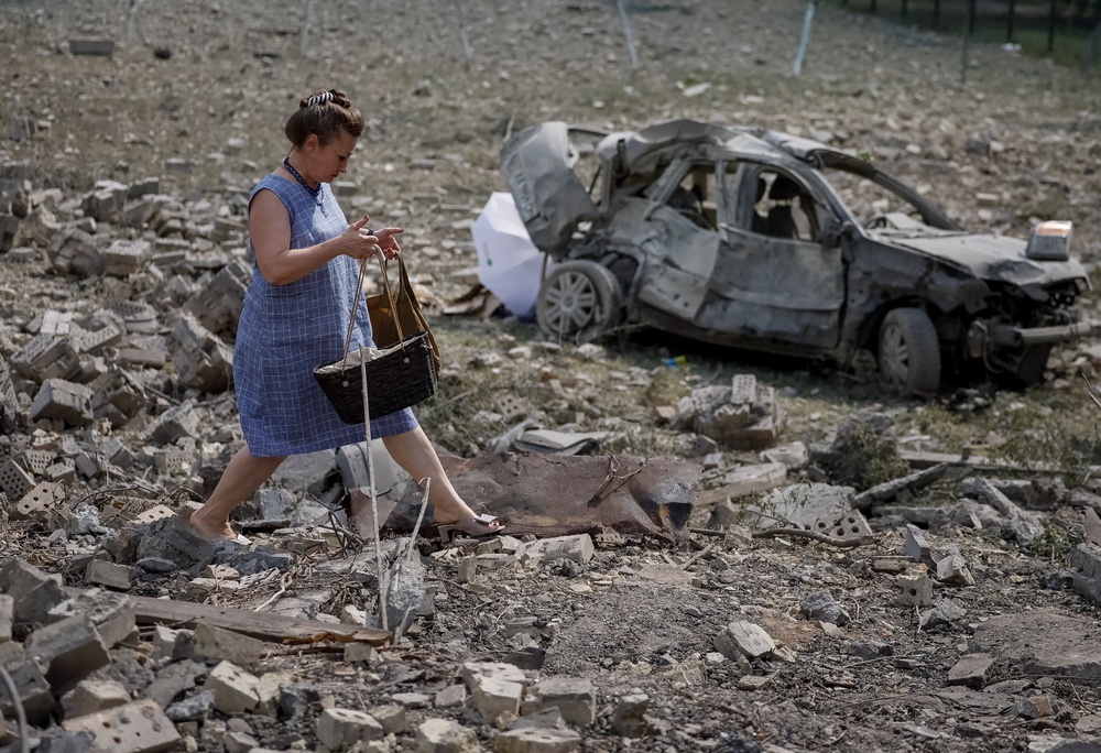 A woman walks at a site of yesterday's missile strike in Kyiv, which was one of the worst since Russia's full-scale invasion began (Reuters)