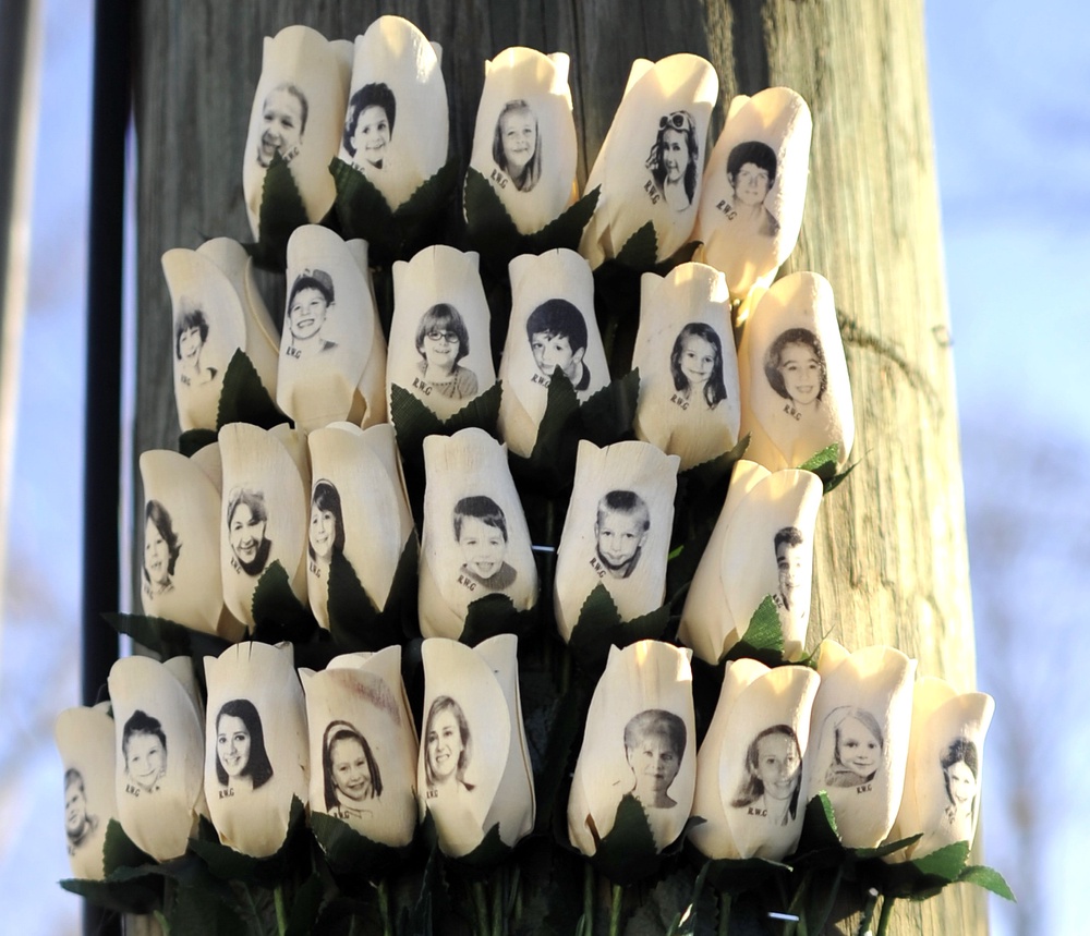 Roses with the faces of the Sandy Hook victims are seen on a pole in Newtown, Connecticut (AFP/Getty)