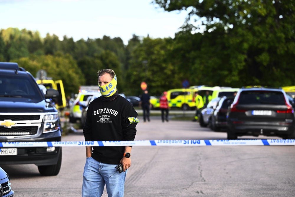 Police and emergency personnel outside Brinellskolan during a major emergency response after a man with a sword reportedly injured several people at the school in Fagersta, Sweden, Friday, Aug. 21, 2026. (Fredrik Sandberg/TT News Agency via AP)