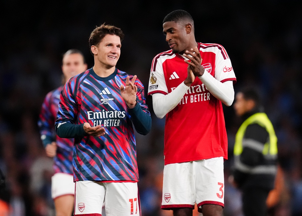 Christos Tzolis and Cristhian Mosquera applaud the Arsenal fans (PA)