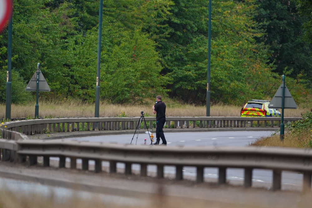 A police officer at the scene of the crash (Owen Humphreys/PA) (PA Wire)