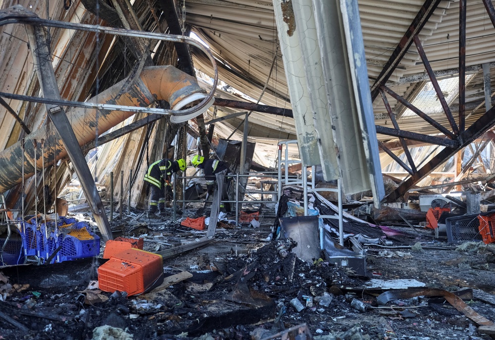 Rescuers work at a site of a shopping centre destroyed by yesterday's Russian drone attack (Reuters)