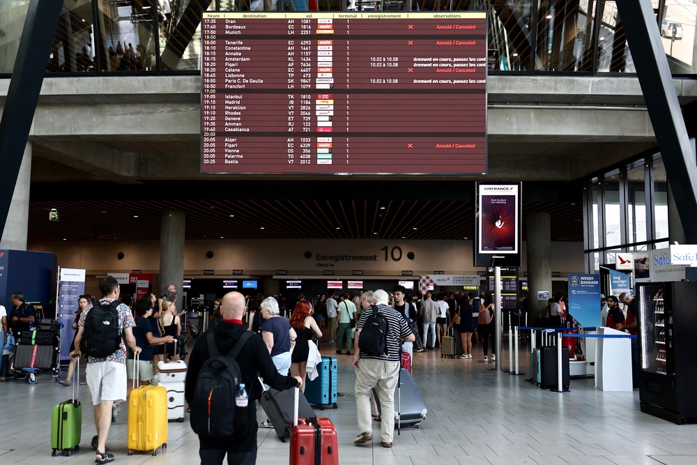 Passengers wait at an airport in Lyon, France, as flights are cancelled due to EasyJet strikes (AFP/Getty)