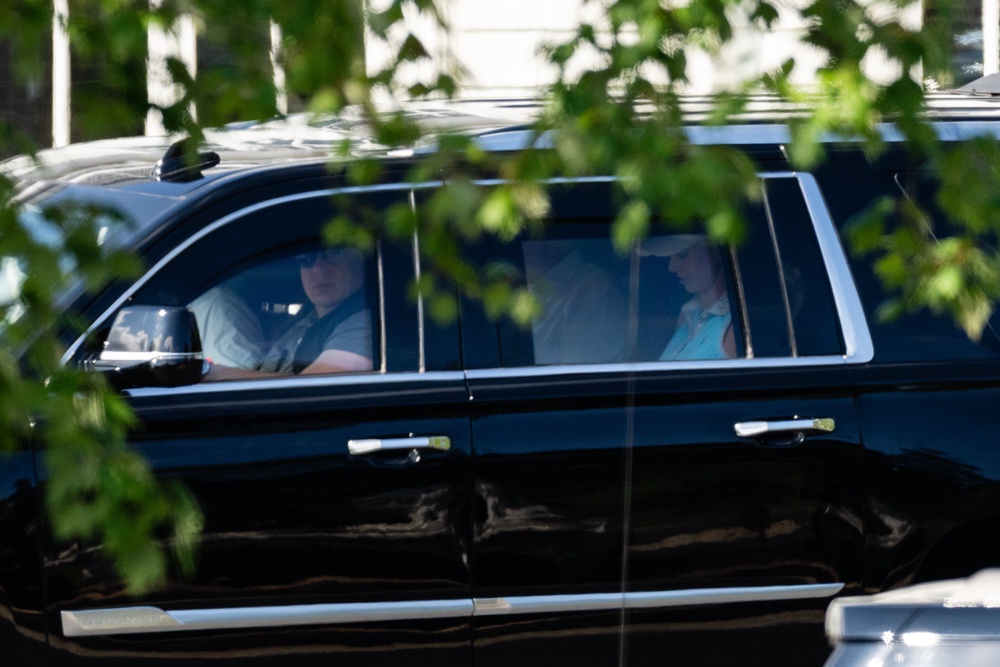 Harp rides in an SUV carrying Trump as they leave Trump National Golf Club (Getty)