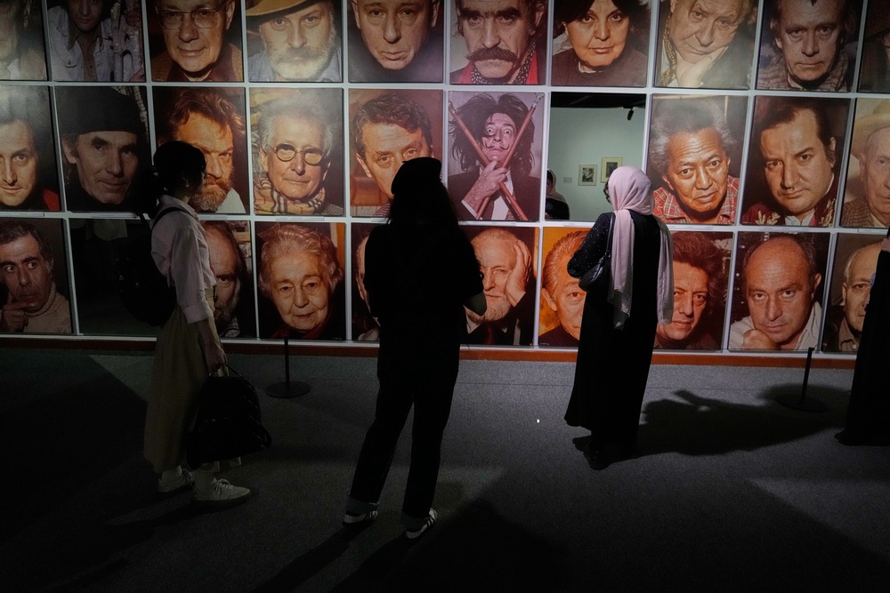 Women visit a photography exhibition showcasing works by international photographers from the collection of the Tehran Museum of Contemporary Art (AP)