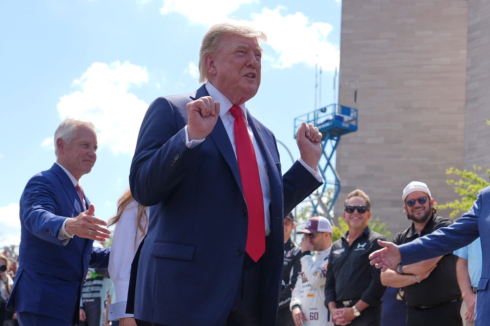 Trump gestures as he arrives at the IndyCar Freedom 250 Grand Prix (AP)
