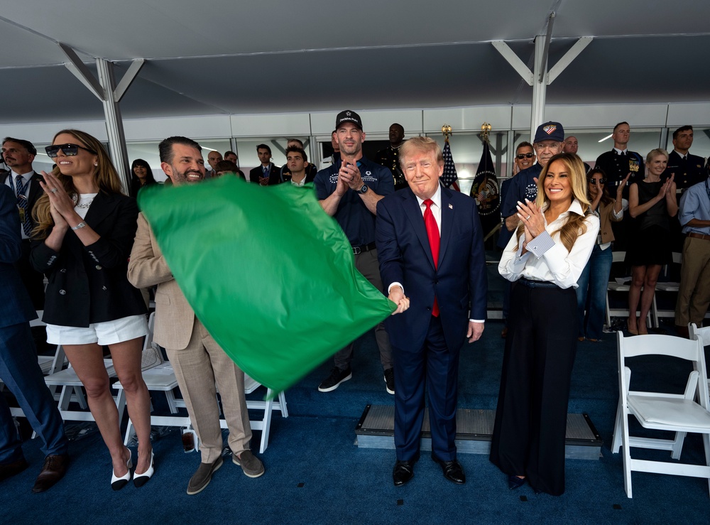 President Trump’s family, members of his administration and close aides, including Natalie Harp (pictured back right), surrounded him in the viewing stands for the Grand Prix (Getty)