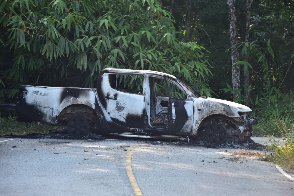 A charred vehicle is seen on a road in Ra-ngae district in the southern Thai province of Narathiwat (AFP/Getty)