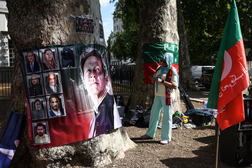 A woman looks at a banner showing Pakistan's jailed former prime minister Imran Khan (AFP/Getty)