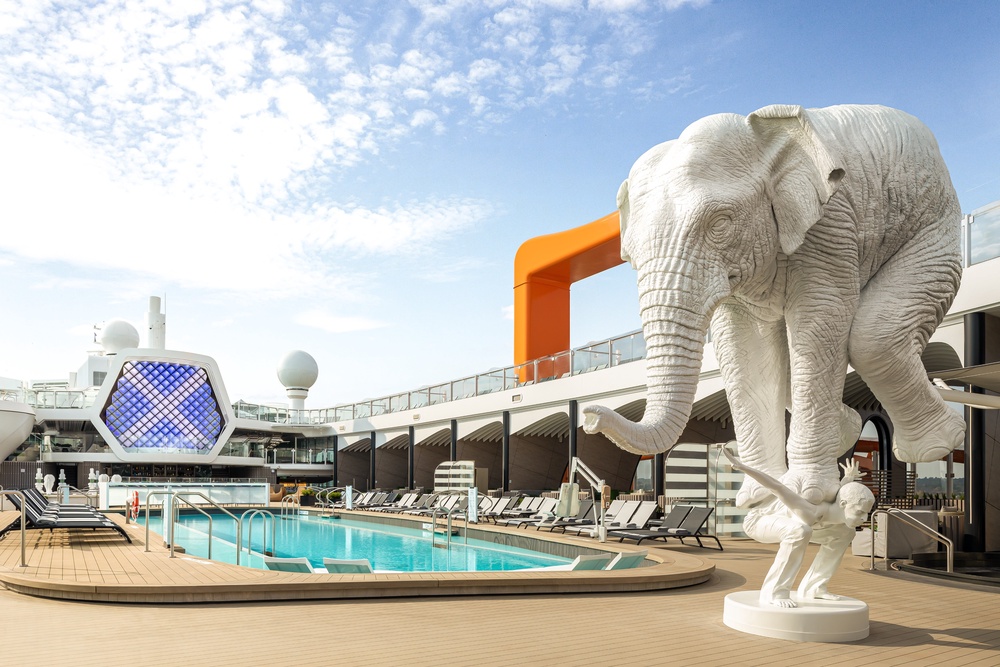 A sculpture of a large elephant balancing on top of a man is a key feature of Beyond's pool deck (Celebrity Cruises)