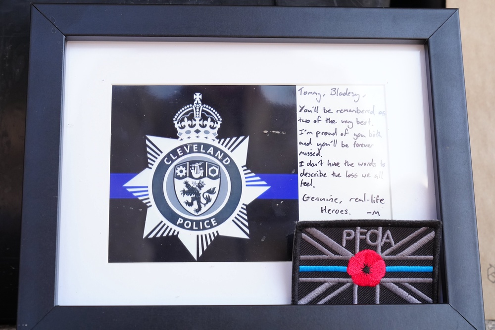 Tributes left outside the Cleveland Police HQ in Middlesbrough (PA)