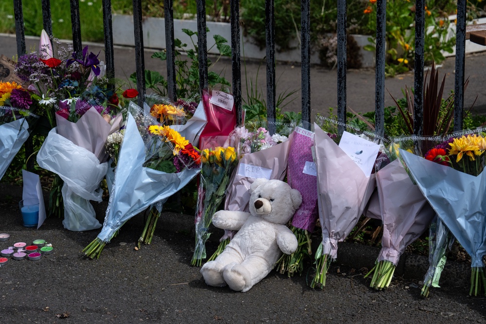 Flowers and tributes for Aalim outside the block of flats where he died (Carl Court/Getty Images)