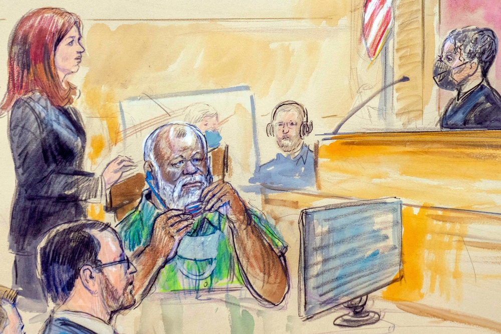 The artist sketch depicts Assistant U.S. Attorney Erik Kenerson, front left, watching as Whitney Minter, a public defender from the eastern division of Virginia, stands to represent Abu Agila Mohammad Mas'ud Kheir Al-Marimi, accused of making the bomb that brought down Pan Am Flight 103 over Lockerbie, Scotland, in 1988, in federal court in Washington, Dec. 12, 2022, as Magistrate Judge Robin Meriweather listens. (Dana Verkouteren via AP) (Dana Verkouteren)