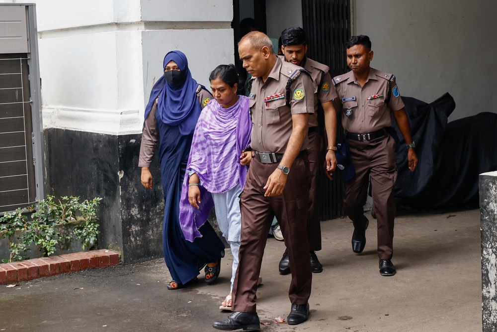 Police escort Ekattor television's former principal correspondent Farzana Rupa, after the International Crimes Tribunal ordered her to remain jailed, in Dhaka, Bangladesh, Monday, 24 Aug 2026 (AP)