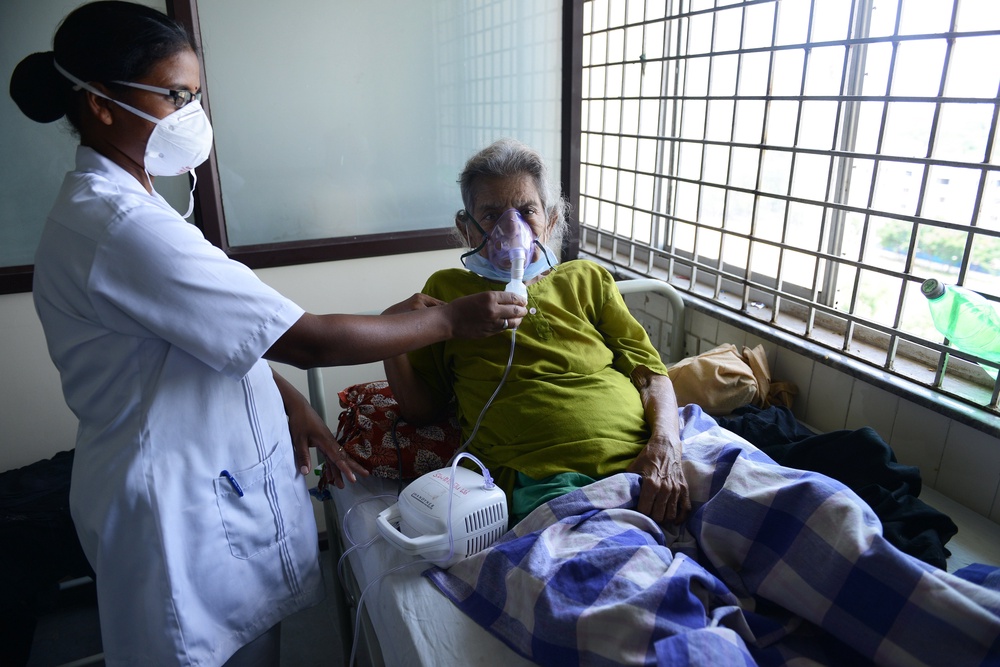 An Indian health professional tends to a patient in a swine flu ward at the Gandhi Hospital in Hyderabad on 24 September 2015 (AFP/Getty)