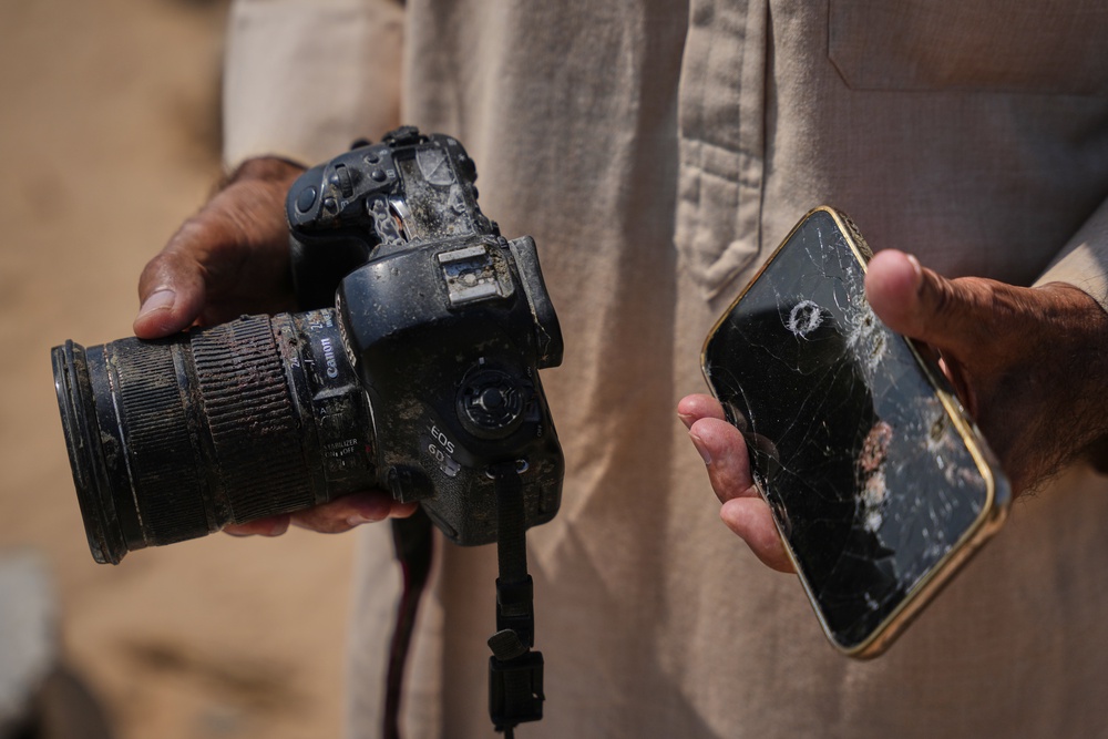 Riyad Abu Dagga, 69, displays the camera and phone belonging to his slain daughter, Mariam Dagga, a freelance journalist who worked with The Associated Press and other news outlets during the Gaza war and was killed in an Israeli airstrike on the Nasser Hospital building in Khan Younis on Aug. 25, 2025, in Khan Younis, Gaza Strip, Aug. 16, 2026. (AP Photo/Abdel Kareem Hana) (Copyright 2026 The Associated Press. All rights reserved.)