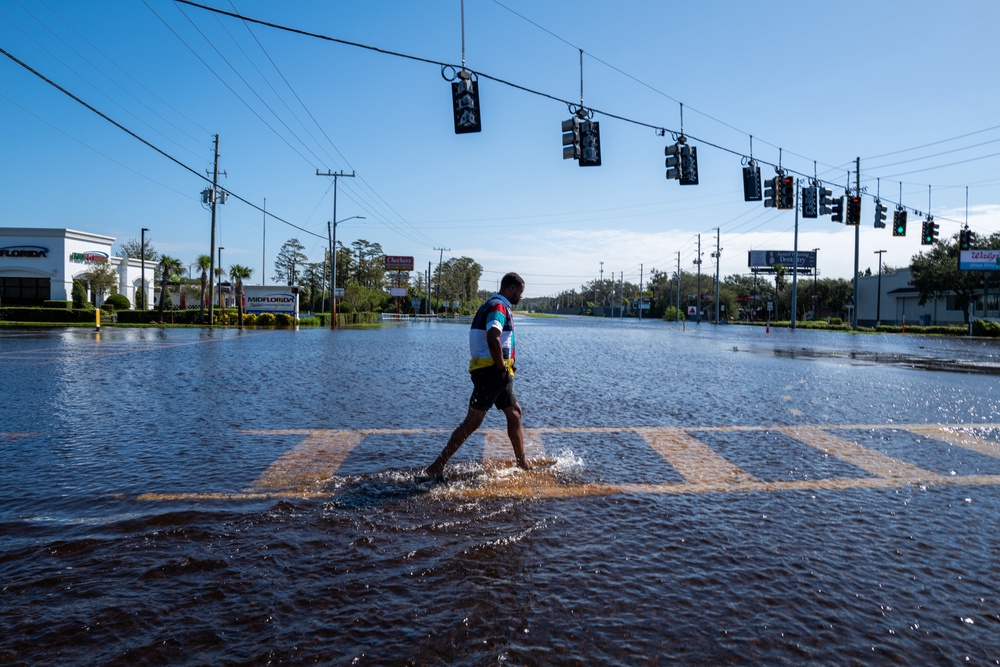 A person walks through a flooded street in New Port Richey, Florida, following Hurricane Milton in October 2024. There was an unusually high number of vibriosis cases after the hurricane (Getty Images)