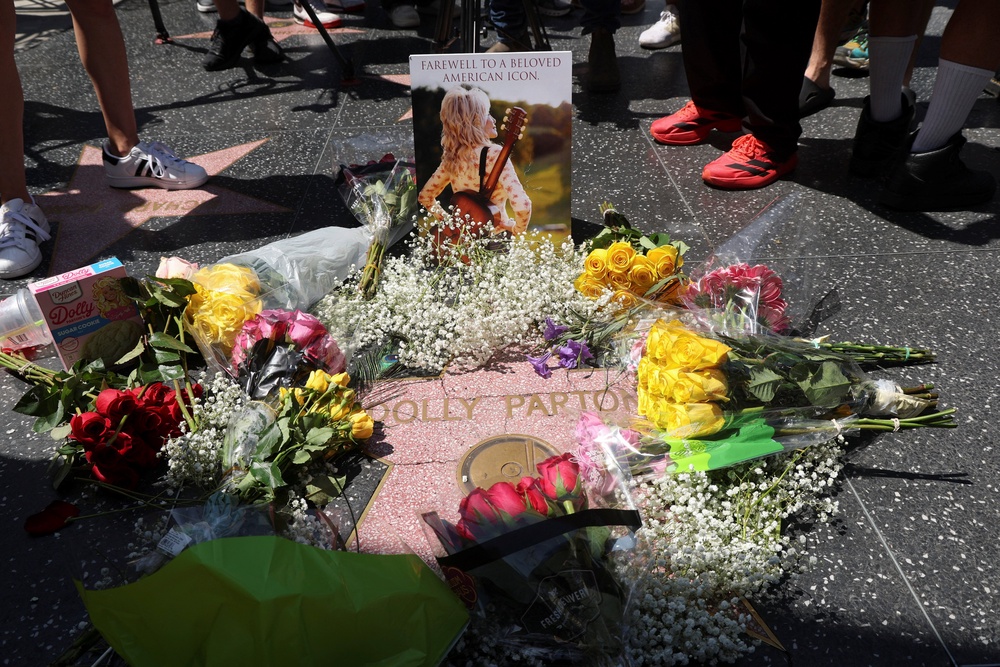 Pictures and flowers have been left at Dolly Parton's star on the Hollywood Walk of Fame (Reuters)