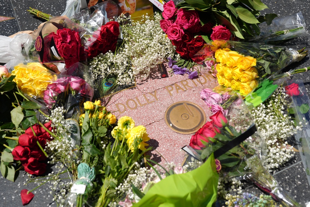 Fans are decorating Dolly Parton's star on the Hollywood Walk of Fame with flowers after her death at age 80 (AP)