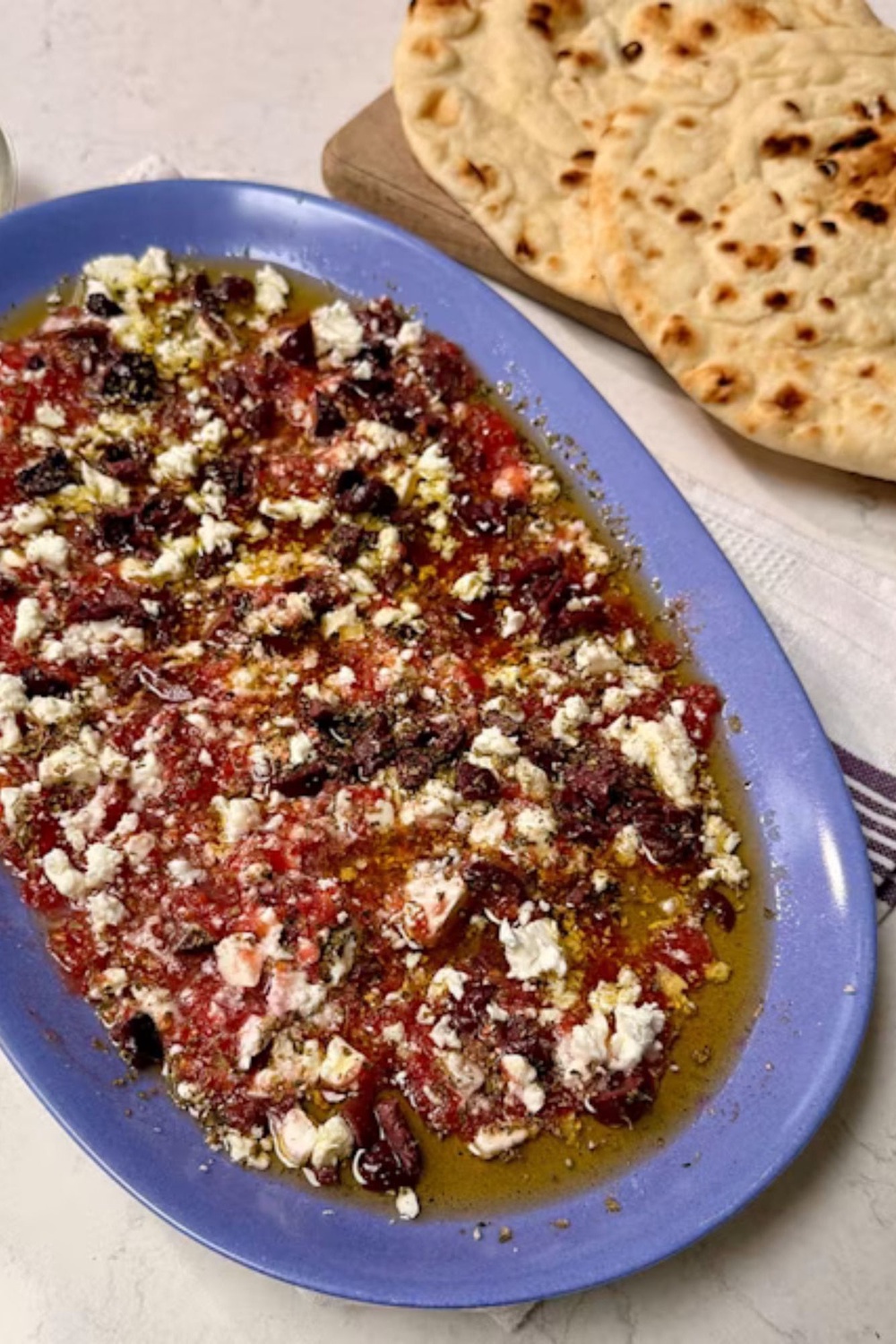 Feta, tomato and olive oil turn a few simple ingredients into something worth tearing bread over (Ocado)