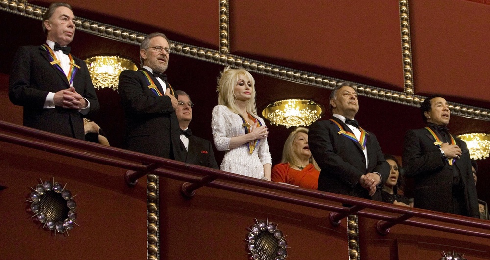 Theatre producer Andrew Lloyd Webber (L), film director Steven Spielberg (2L), singer Dolly Parton (C), conductor Zubin Metha (2nd R) and singer Smokey Robinson (R) stand for the national anthem during the 2006 Kennedy Center Honors taping (AFP/Getty)