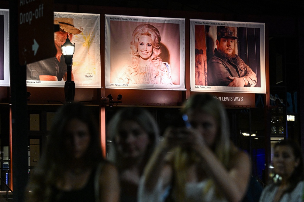 Fans gather near a photo of the late US singer-songwriter Dolly Parton displayed at the Country Music Hall of Fame and Museum in Nashville, Tennessee (AFP/Getty)