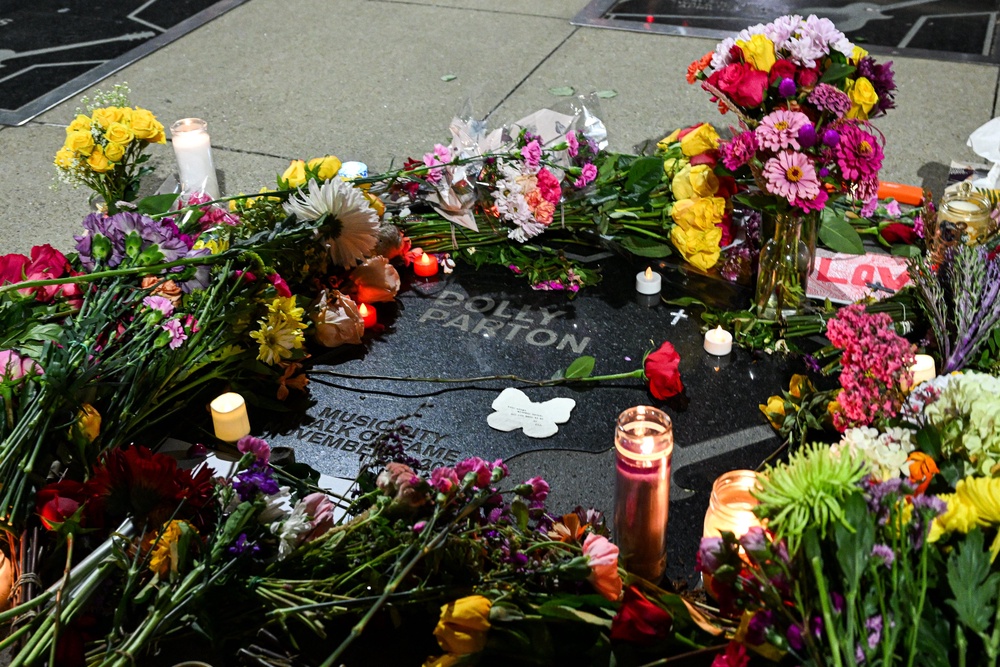 Flowers and candles, placed by fans, cover Dolly Parton's star on The Music City Walk of Fame in Nashville, Tennessee (AFP/Getty)