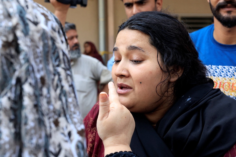 Javeria, mother of a newborn victim, is consoled following a deadly fire at Pims hospital in Islamabad (Reuters)