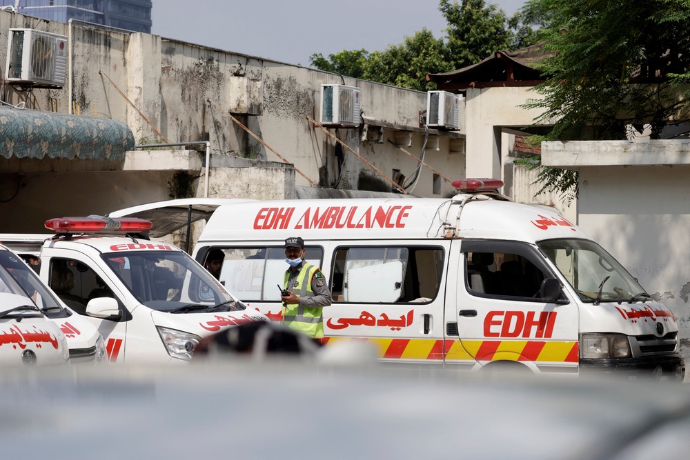 Ambulances are parked outside a mortuary following a deadly fire at the Pims hospital in Islamabad (Reuters)